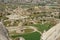 Beautiful inspiring scenic panoramic landscape view of rock cave from red valley with Goreme town background, Cappadocia