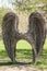 Beautiful, interesting angel wings are made of branches in the park. Place for photo shoots