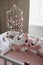 Beautiful interior of baby room with a crib. White crib with pillows and pink blanket in baby room. pastel pink bedding