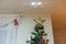 Beautiful interior view of room adorned with Christmas tree topped with gold star and electrical projection