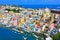 Beautiful island town in Italy, aerial view of harbor and colorful pastel buildings of Procida