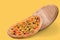 Beautiful italian pizza slides from a round board to a yellow surface, food concept in pastel colors