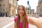 Beautiful Italy. Attractive smiling young woman take self portrait in Piazza del Nettuno square Bologna city, Italy