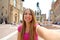 Beautiful Italy. Attractive smiling young woman take self portrait in Piazza del Nettuno square Bologna city, Italy