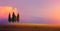 Beautiful Italy nature countryside landscape; farm field and cypress trees over sunset sky