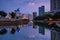 Beautiful Jakarta city in sunset, buildings reflected on water, Indonesia