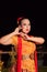 Beautiful Javanese woman with a golden necklace on her neck and golden belt on a yellow dress on their body