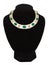 Beautiful jewellery necklace with green stone on black mannequin