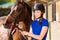 Beautiful jockey girl with her purebred bay horse