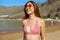 Beautiful joyful girl in bikini enjoying tropical beach in her summer vacation