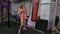 Beautiful Kickboxing woman training punching bag in fitness gym. slow motion