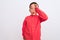 Beautiful kid boy wearing elegant red shirt standing over isolated white background doing ok gesture shocked with surprised face,