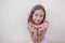 Beautiful kid girl eating watermelon over white background. Family love and lifestyle outdoors