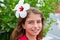 Beautiful kid girl with hibiscus flower in hair