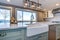 Beautiful kitchen room with green island and farm sink.