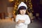 beautiful Korean child girl in in a white knitted sweater