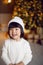 beautiful Korean child girl in in a white knitted sweater