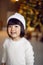 beautiful Korean child girl in in a white knitted sweater