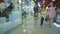 Beautiful ladies walking in a store with shopping bags. Slow motion.