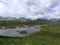 Beautiful ladscape on the mountain lake surrounded by mountains. Snow on the mountains. Small lake in Norway.