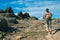 Beautiful lady backpacker climbing mountain path