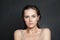 Beautiful lady brunette portrait. Wellness model woman with healthy skin posing on black studio wall background