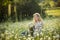 Beautiful lady with cute daughter on camomile field