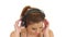 Beautiful lady listening music in large headphones, looking at camera and making blow kisses