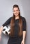 A beautiful lady with long hair in a dress. She poses with a soccer ball. Love for sports and football. Photo1