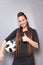 A beautiful lady with long hair in a dress. She poses with a soccer ball. Love for sports and football. Photo3