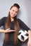 A beautiful lady with long hair in a dress. She poses with a soccer ball. Love for sports and football. Photo4