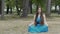 Beautiful lady meditation outdoors, long hair woman brunette in park, lotus pose
