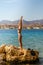 Beautiful lady practicing yoga on the beach cliff