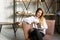 Beautiful lady sitting in a armchair and reading a book. Young serene woman relaxing at home and reading a book in the sun light