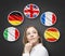 Beautiful lady is surrounded by bubbles with european countries\' flags (Italian, German, Great Britain, French, Spanish). Learning