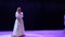 Beautiful lady in white dress sing sensual song on the stage