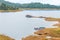 Beautiful lake with boats, covered with mountain and forest