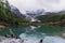 Beautiful lake with forests and mountain at the last Shangri-la, Yading nature reserve in Sichuan, China