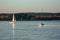 Beautiful lake landscape, yacht, balloon, birds and sunset. Blue waves, boat and horizon line on water