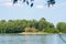 A beautiful lake and lots of greenery around. Forest in the background. A beautiful view