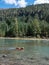 Beautiful lake and mountains, golden retriever swimming in the lake