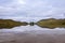 Beautiful lake with reflections of the trees and surrounding mountains in the Scottish Highlands, in Scotland, United Kingdom