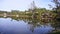 Beautiful Lake At A Resort With Reflection of Trees and Kiosk - Pan - Right To Left