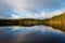 Beautiful lake scenery in Finland. Water mirroring  the sky and the woods