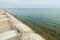 Beautiful lake shore nature  view with concrete embankment and wall leading into the water