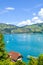 Beautiful Lake Thun in Switzerland photographed with sailboats during the summer season. Green hills in the background. Swiss