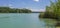 Beautiful Lake WÃ¶rthsee with Island WÃ¶rth taken from a pier. Green Landscape with cottage, reed and aquatic plants on a clear,