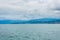 Beautiful lake Zurich landscape. Cloudy skyscape with  background of Alps mountains peaks