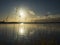 Beautiful lakescape of the calm lake over the sunset and some thin grasses