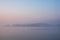 Beautiful landcape image of Spring sunrise over reservoir lake with dawn glow spreading aross the water with low mist adding